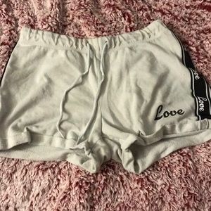 These are White-ish shorts that say love